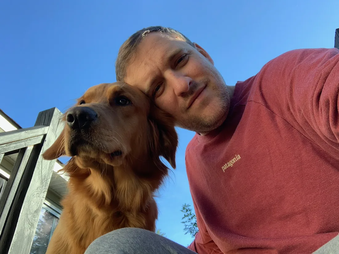 Phil outside with Ruby, the family&rsquo;s golden retriever.